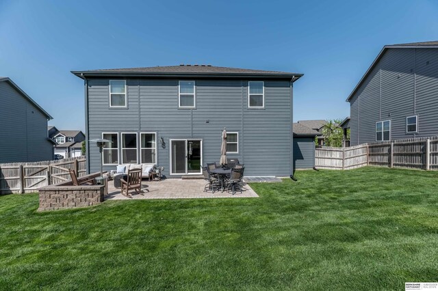 rear view of property featuring a patio area and an outdoor hangout area