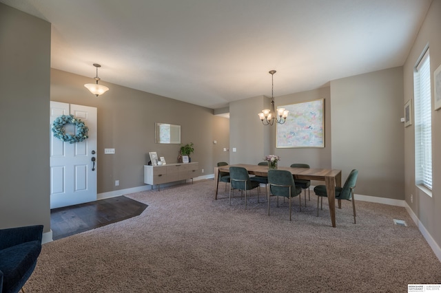 dining room with carpet flooring, a chandelier, and baseboards