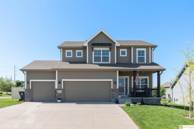 craftsman-style house with a porch, a front yard, driveway, a garage, and board and batten siding