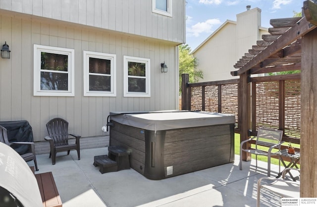 2103 John St, Papillion, NE 68133 - view of patio featuring a hot tub and a pergola