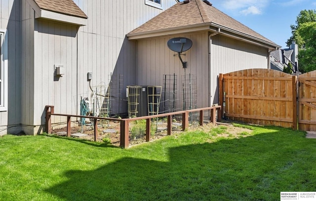 2103 John St, Papillion, NE 68133 - back of property with roof with shingles, central AC, and a gate