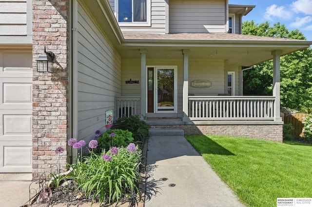 2103 John St, Papillion, NE 68133 - property entrance featuring covered porch, a yard, and a shingled roof