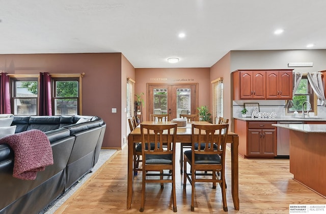 2103 John St, Papillion, NE 68133 - dining area featuring light wood-style flooring, healthy amount of natural light, and recessed lighting
