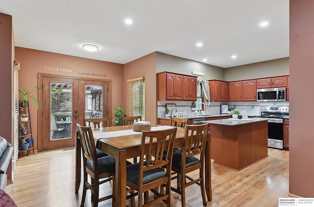 2103 John St, Papillion, NE 68133 - dining room featuring light wood finished floors, french doors, and recessed lighting