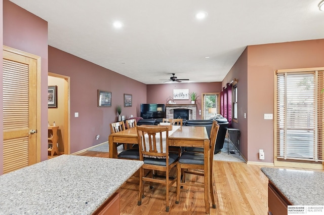 2103 John St, Papillion, NE 68133 - dining area with a fireplace, light wood-type flooring, a ceiling fan, plenty of natural light, and recessed lighting