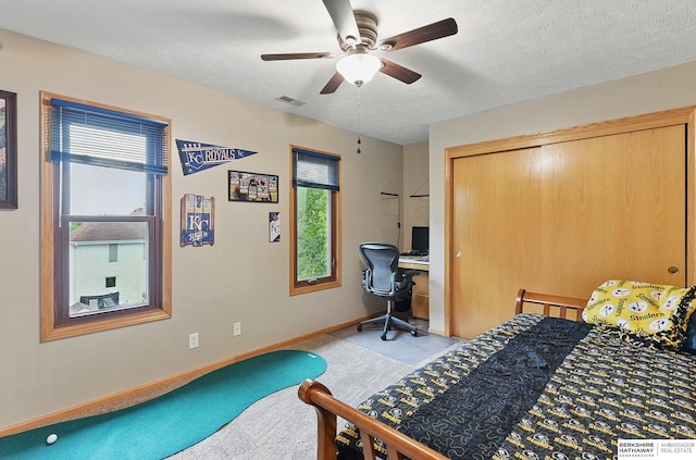 2103 John St, Papillion, NE 68133 - bedroom featuring an office area, carpet flooring, baseboards, ceiling fan, and a textured ceiling