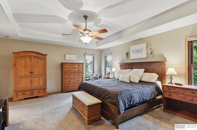 2103 John St, Papillion, NE 68133 - bedroom featuring a raised ceiling, multiple windows, light colored carpet, and ceiling fan