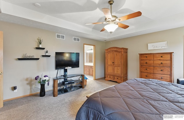 2103 John St, Papillion, NE 68133 - carpeted bedroom with baseboards, a ceiling fan, a tray ceiling, and ensuite bathroom