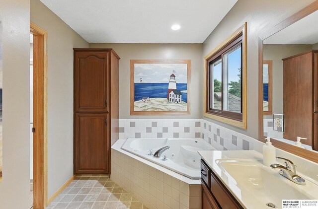 2103 John St, Papillion, NE 68133 - bathroom featuring vanity, a whirlpool tub, and tile patterned flooring