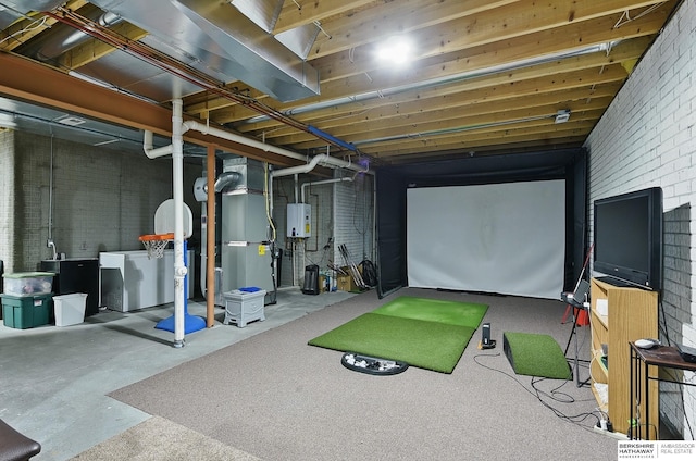 2103 John St, Papillion, NE 68133 - playroom with tankless water heater, washer / clothes dryer, heating unit, concrete flooring, and brick wall