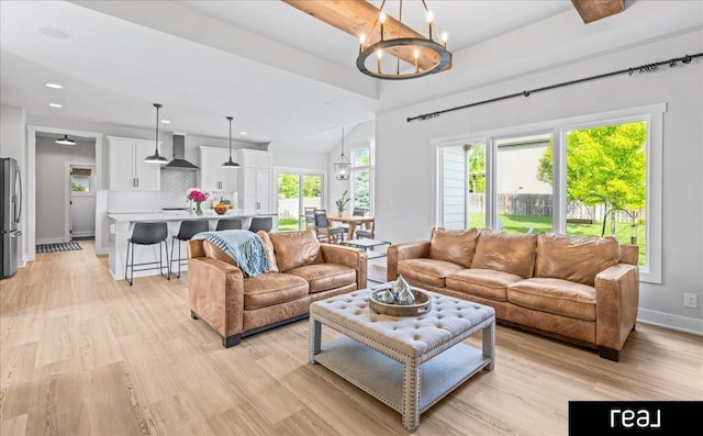 18880 Patrick Cir, Elkhorn, NE 68022 - living area featuring light wood finished floors, a chandelier, recessed lighting, and baseboards