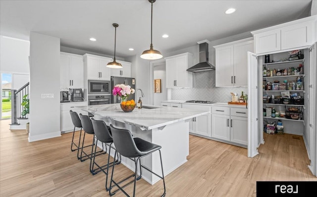18880 Patrick Cir, Elkhorn, NE 68022 - kitchen with wall chimney range hood, stainless steel appliances, a sink, decorative backsplash, and white cabinetry