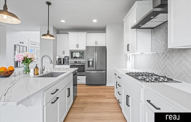 18880 Patrick Cir, Elkhorn, NE 68022 - kitchen with stainless steel appliances, wall chimney range hood, a sink, white cabinets, and recessed lighting