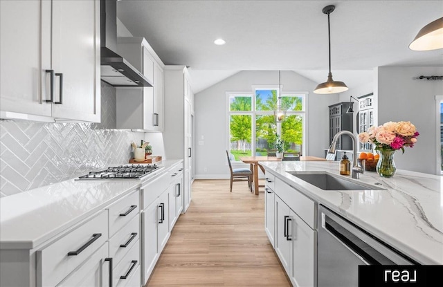18880 Patrick Cir, Elkhorn, NE 68022 - kitchen with a sink, wall chimney exhaust hood, tasteful backsplash, appliances with stainless steel finishes, and vaulted ceiling