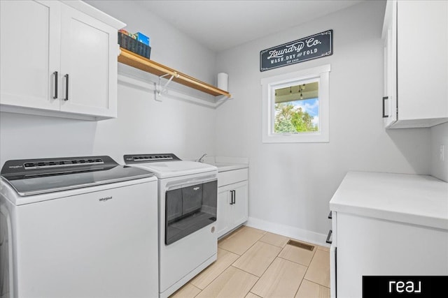 18880 Patrick Cir, Elkhorn, NE 68022 - washroom featuring washer and dryer, cabinet space, and baseboards