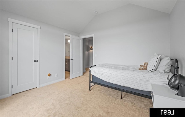 18880 Patrick Cir, Elkhorn, NE 68022 - bedroom featuring vaulted ceiling, light carpet, baseboards, and ensuite bath