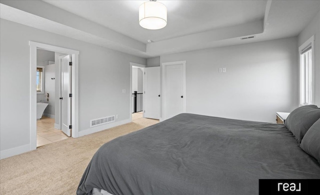 18880 Patrick Cir, Elkhorn, NE 68022 - bedroom featuring light colored carpet, baseboards, light tile patterned floors, and connected bathroom