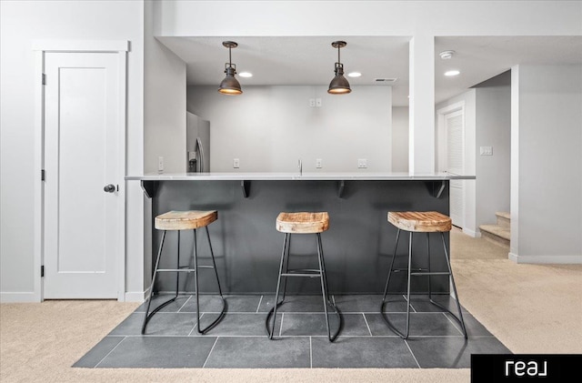 18880 Patrick Cir, Elkhorn, NE 68022 - bar area featuring carpet flooring, stainless steel fridge with ice dispenser, stairs, baseboards, and pendant lighting