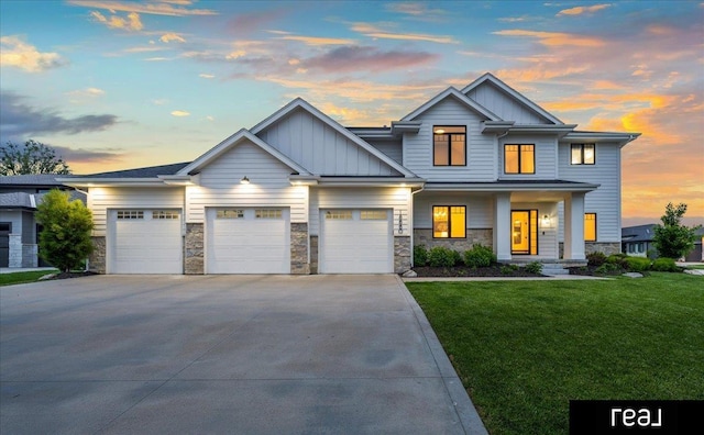 18880 Patrick Cir, Elkhorn, NE 68022 - view of front of property with board and batten siding, a front lawn, concrete driveway, and a garage