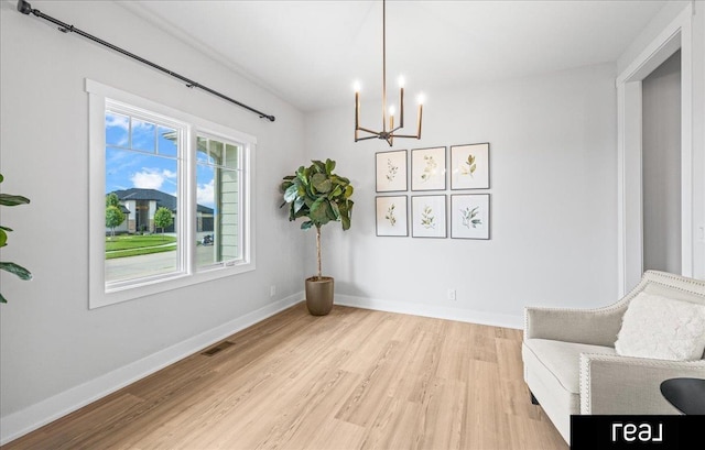 18880 Patrick Cir, Elkhorn, NE 68022 - unfurnished room featuring light wood-style flooring, a chandelier, and baseboards