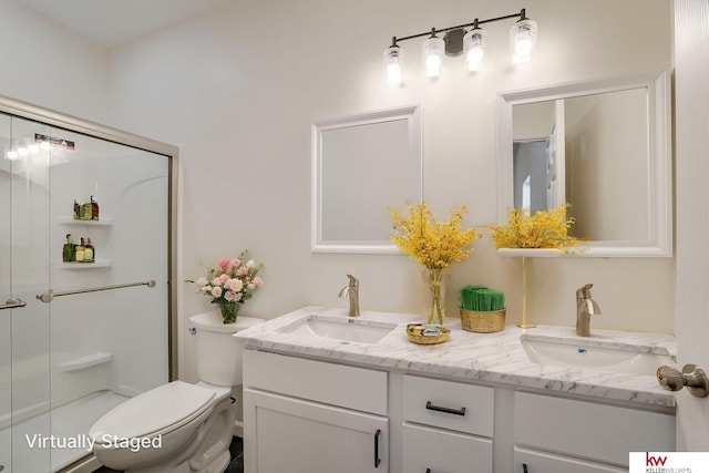 full bathroom featuring a stall shower, toilet, and double vanity