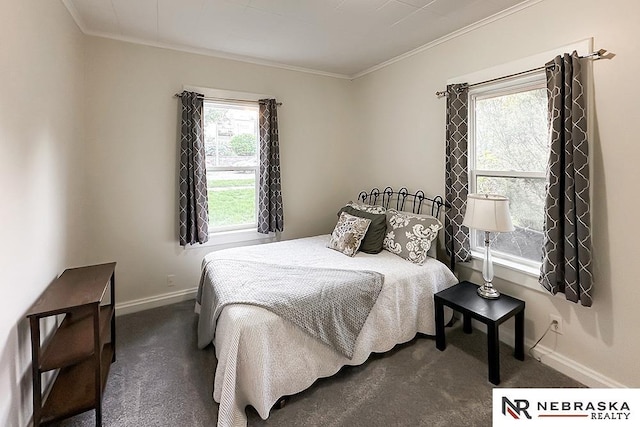bedroom with ornamental molding, dark colored carpet, and baseboards
