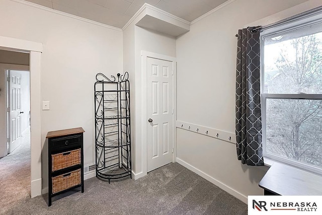 unfurnished room featuring crown molding, carpet, and baseboards