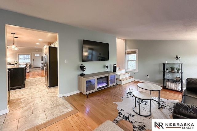 living room featuring light wood-style flooring and baseboards