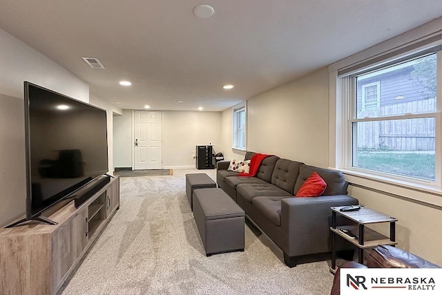 living area featuring light colored carpet, recessed lighting, and baseboards