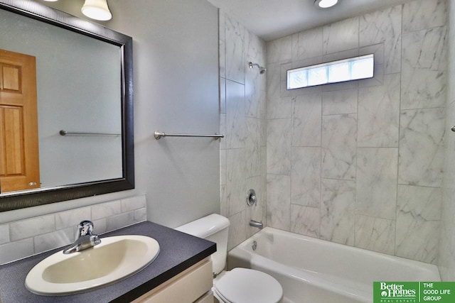 bathroom with backsplash, toilet, vanity, and bathtub / shower combination