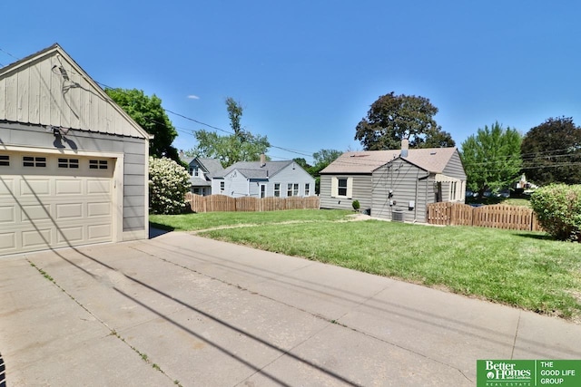 view of front of property with driveway, a detached garage, and board and batten siding