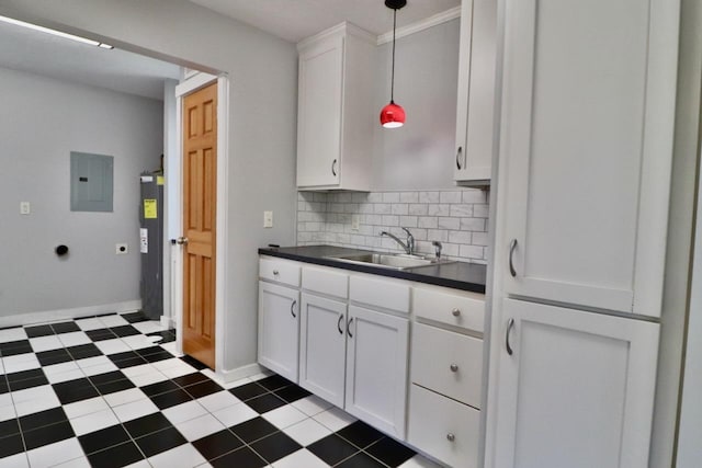 kitchen with electric panel, a sink, white cabinetry, decorative backsplash, and decorative light fixtures