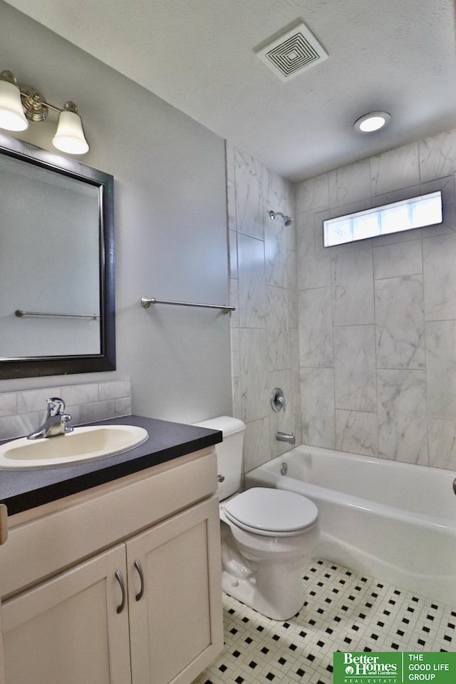 bathroom with tub / shower combination, toilet, vanity, and tile patterned flooring