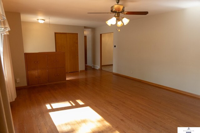 5 Fairview Dr, York, NE 68467 - unfurnished room featuring light wood-style floors, a ceiling fan, and baseboards