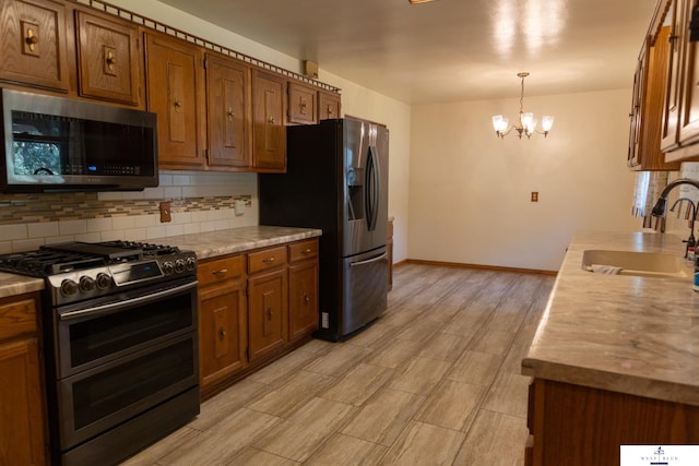 5 Fairview Dr, York, NE 68467 - kitchen featuring stainless steel appliances, a sink, brown cabinets, and decorative backsplash