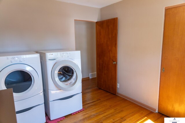 5 Fairview Dr, York, NE 68467 - clothes washing area with washing machine and clothes dryer, light wood-style flooring, and baseboards