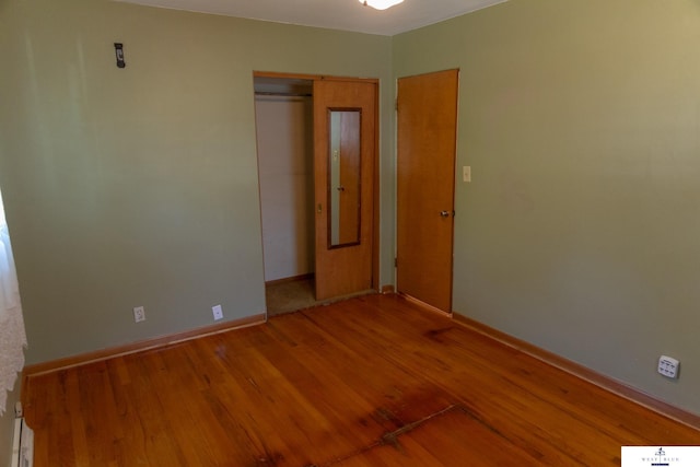 5 Fairview Dr, York, NE 68467 - unfurnished bedroom featuring wood finished floors, baseboards, and a closet
