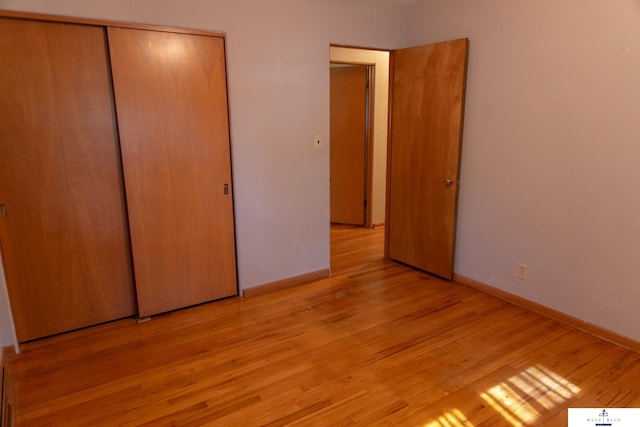5 Fairview Dr, York, NE 68467 - unfurnished bedroom with light wood-style floors, a closet, and baseboards