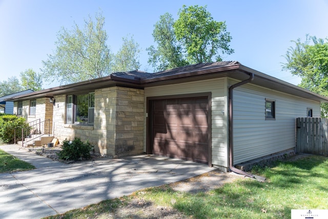 5 Fairview Dr, York, NE 68467 - view of property exterior with a garage, driveway, and stone siding