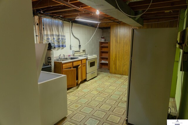 5 Fairview Dr, York, NE 68467 - unfinished below grade area featuring freestanding refrigerator, a sink, light floors, and concrete block wall