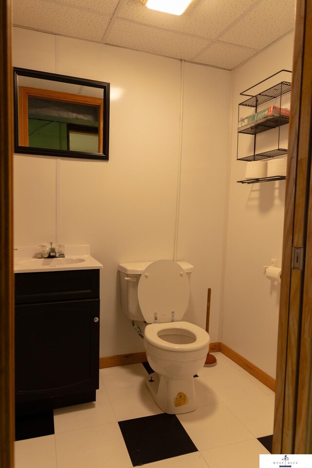 5 Fairview Dr, York, NE 68467 - half bath featuring a paneled ceiling, toilet, vanity, and baseboards