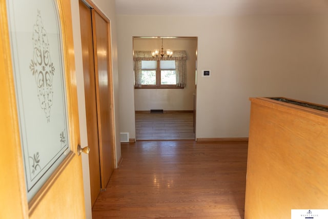 5 Fairview Dr, York, NE 68467 - hallway featuring a chandelier, wood finished floors, and baseboards