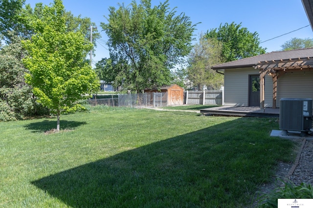 5 Fairview Dr, York, NE 68467 - view of yard with cooling unit, a wooden deck, a pergola, a storage shed, and an outbuilding