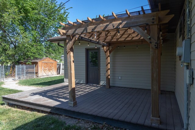 5 Fairview Dr, York, NE 68467 - wooden terrace featuring a storage shed, a pergola, fence, and an outbuilding