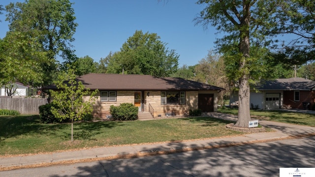 5 Fairview Dr, York, NE 68467 - ranch-style home with a garage, stone siding, and driveway