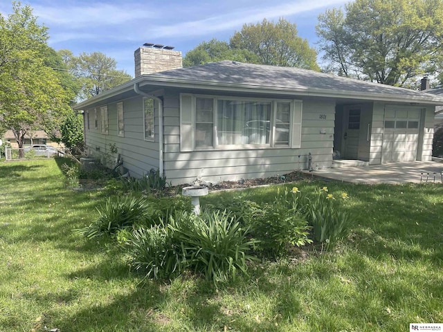 1801 Franklin St, Bellevue, NE 68005 - bungalow featuring an attached garage, a chimney, a front yard, and roof with shingles