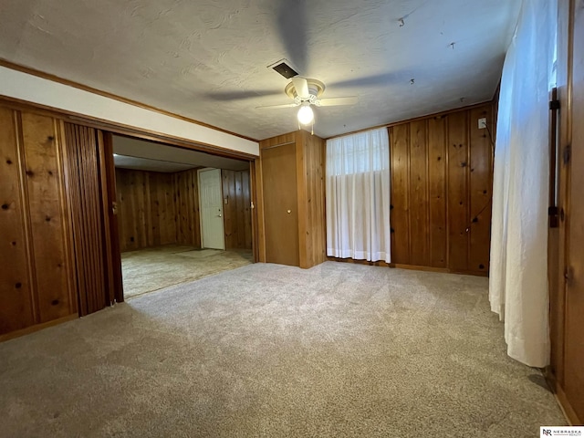 1801 Franklin St, Bellevue, NE 68005 - unfurnished bedroom featuring wood walls, carpet, and ceiling fan