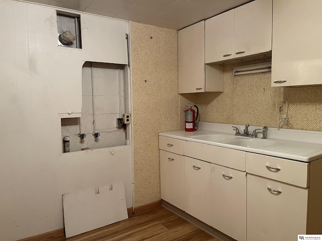 1801 Franklin St, Bellevue, NE 68005 - kitchen with light countertops, light wood finished floors, backsplash, and white cabinets