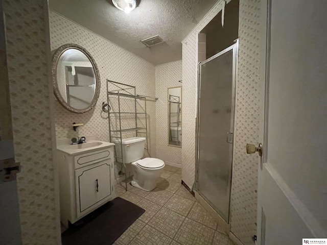 1801 Franklin St, Bellevue, NE 68005 - full bathroom featuring vanity, toilet, a stall shower, tile patterned flooring, and a textured ceiling