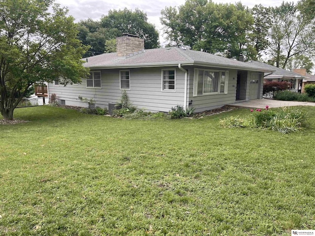 1801 Franklin St, Bellevue, NE 68005 - view of front of home featuring a chimney, a front yard, and an attached garage